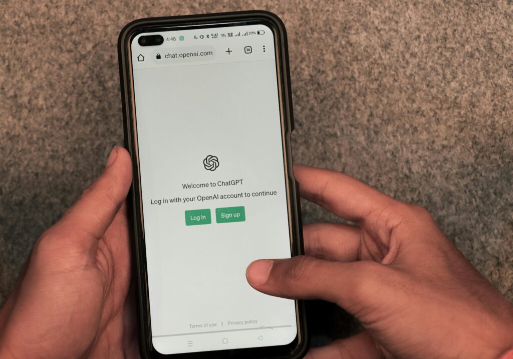 Tradie accessing ChatGPT login on mobile phone to streamline service admin tasks